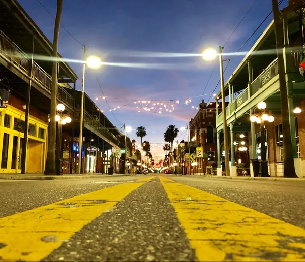 Historic 7th Avenue in Ybor City, Tampa, at night under string lights